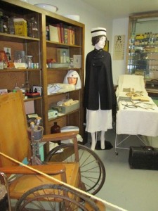 A doctor's office from the past with a nurse on duty. 